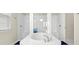 Luxurious main bathroom with large soaking tub, marble surround, and dual shower heads at 7163 Talamore Dr, Wesley Chapel, FL 33545