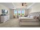 Spacious main bedroom featuring plush carpet, tray ceiling, and a king-size bed at 7163 Talamore Dr, Wesley Chapel, FL 33545