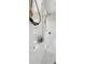 Elegant walk-in shower featuring a sleek design, rain shower head, and marble tile at 7163 Talamore Dr, Wesley Chapel, FL 33545