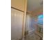 Bathtub area with white tiled walls and a shower curtain with a leafy design at 10937 Bluestem Cir, Lakewood Ranch, FL 34202