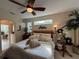 Inviting main bedroom with stylish decor, a ceiling fan, and a comfortable ambiance at 10937 Bluestem Cir, Lakewood Ranch, FL 34202