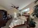 Cozy main bedroom featuring a large bed, accent furniture, and natural lighting at 10937 Bluestem Cir, Lakewood Ranch, FL 34202