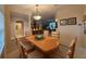 Elegant dining room with a wood table, seating for six, and decorative lighting fixture at 10937 Bluestem Cir, Lakewood Ranch, FL 34202