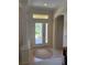 Bright foyer featuring double-glass doors, tile flooring, and an elegant column at 10937 Bluestem Cir, Lakewood Ranch, FL 34202
