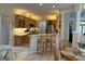 Open kitchen design with a breakfast bar, stainless steel appliances, and built-in cabinets at 10937 Bluestem Cir, Lakewood Ranch, FL 34202