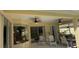 Covered lanai boasts a seating area, ceiling fans, and access to the pool at 10937 Bluestem Cir, Lakewood Ranch, FL 34202