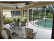 Screened-in lanai features a seating area and view of the pool with protective fence at 10937 Bluestem Cir, Lakewood Ranch, FL 34202