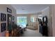 An open concept home shows the living area with decor and a view of the outdoor pool at 10937 Bluestem Cir, Lakewood Ranch, FL 34202