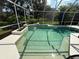 Screened-in pool with steps leading into the water and lush backyard landscaping at 10937 Bluestem Cir, Lakewood Ranch, FL 34202