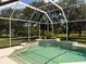 Screened-in pool and patio area with a waterfall feature and lush landscaping at 10937 Bluestem Cir, Lakewood Ranch, FL 34202