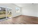 Spacious living room featuring wood flooring, a sliding glass door, and a window at 11955 Sylvia St, Dade City, FL 33525