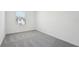 Bright bedroom features a window bringing in natural light and soft neutral carpet at 11975 Sylvia St, Dade City, FL 33525