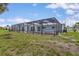 View of the backyard featuring a pool, spa, enclosure, and canal at 1764 Boca Raton Ct, Punta Gorda, FL 33950