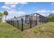 Fenced backyard with a view of the house, screened-in pool, and patio at 1764 Boca Raton Ct, Punta Gorda, FL 33950