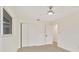 Bedroom with neutral tile flooring, ceiling fan, closet, and access to other rooms at 1764 Boca Raton Ct, Punta Gorda, FL 33950
