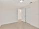 Bright bedroom with a ceiling fan and a doorway leading to another room at 1764 Boca Raton Ct, Punta Gorda, FL 33950