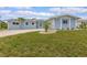 Well-maintained single-story home with lush green lawn and inviting curb appeal at 1764 Boca Raton Ct, Punta Gorda, FL 33950