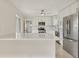 Well-lit kitchen with an island, stainless steel refrigerator, and white cabinets at 1764 Boca Raton Ct, Punta Gorda, FL 33950