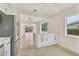 Bright kitchen with white cabinetry, stainless steel appliances and kitchen island at 1764 Boca Raton Ct, Punta Gorda, FL 33950
