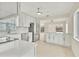 Bright kitchen featuring white cabinetry, stainless steel appliances, and a breakfast bar area at 1764 Boca Raton Ct, Punta Gorda, FL 33950