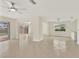 Large open living area with tile flooring, fan, and views of the outdoor space at 1764 Boca Raton Ct, Punta Gorda, FL 33950