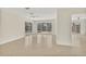 Bright living room with neutral tile flooring and sliding glass doors to the outdoor pool and waterfront at 1764 Boca Raton Ct, Punta Gorda, FL 33950