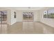 Open living area featuring tile floors, bright interiors, and sliding glass doors at 1764 Boca Raton Ct, Punta Gorda, FL 33950