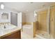 Bathroom featuring tiled shower, soaking tub, and double sink vanity at 20214 Water Hickory Pl, Tampa, FL 33647