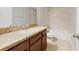 Bathroom featuring vanity with laminate countertops, a shower-tub combo, and tile floors at 20214 Water Hickory Pl, Tampa, FL 33647