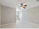 Spacious bedroom with neutral walls, plush carpet, and a ceiling fan at 20214 Water Hickory Pl, Tampa, FL 33647