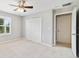 Bedroom with carpet, closet and a ceiling fan with light at 20214 Water Hickory Pl, Tampa, FL 33647