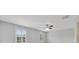 Bright bedroom featuring plantation shutters, a ceiling fan and neutral carpet at 20214 Water Hickory Pl, Tampa, FL 33647