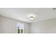 Bedroom featuring a ceiling light and bright window with plantation shutters at 20214 Water Hickory Pl, Tampa, FL 33647