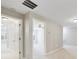 Hallway featuring neutral colored walls, carpet, and white doors at 20214 Water Hickory Pl, Tampa, FL 33647