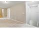 Bright hallway with neutral carpet, leading to staircase and bedrooms at 20214 Water Hickory Pl, Tampa, FL 33647
