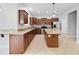 Bright kitchen with brown cabinets, granite countertops, and stainless-steel appliances at 20214 Water Hickory Pl, Tampa, FL 33647