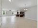 Open living area with tile flooring and ample natural light flows into the kitchen at 20214 Water Hickory Pl, Tampa, FL 33647
