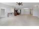 Open concept living room and kitchen area with tile flooring, ceiling fan and natural light at 20214 Water Hickory Pl, Tampa, FL 33647