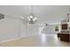 A bright open concept living room features tile floors and decorative light fixture at 20214 Water Hickory Pl, Tampa, FL 33647