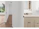 A partial view of a bathroom featuring a vanity with a lighted mirror at 2421 Valkaria Ave, North Port, FL 34286
