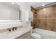 Bathroom featuring shower and tub combo with stylish fixtures, and a vanity with an illuminated mirror at 2421 Valkaria Ave, North Port, FL 34286