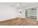 This bedroom features hardwood floors, a ceiling fan, and sliding glass doors at 2421 Valkaria Ave, North Port, FL 34286