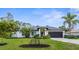 Charming renovated single-story home with a well-manicured lawn, mature landscaping, and a two-car garage at 2421 Valkaria Ave, North Port, FL 34286