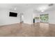 Open concept living space with tile flooring, neutral walls, and sliding glass doors leading to outdoor space at 2421 Valkaria Ave, North Port, FL 34286