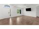 Bright living room features tile floors, large window, and a freshly painted white walls at 2421 Valkaria Ave, North Port, FL 34286