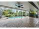 Enclosed lanai with a small pool featuring a paved patio and ceiling fans for comfortable outdoor living at 2421 Valkaria Ave, North Port, FL 34286