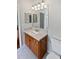 Bathroom featuring a wood vanity, single sink, large mirror, and tile flooring at 2936 Banyan Hill Ln, Land O Lakes, FL 34639