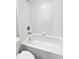 The bathroom features a sleek, white tiled shower-tub combination and modern fixtures at 2936 Banyan Hill Ln, Land O Lakes, FL 34639