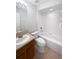 Bright bathroom featuring a vanity, toilet, and a shower-tub combination with white tiling at 2936 Banyan Hill Ln, Land O Lakes, FL 34639