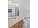 Well-lit bathroom with a vanity, toilet, and accessible shower at 2936 Banyan Hill Ln, Land O Lakes, FL 34639